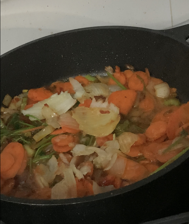 Frying Carrot Rings and Tomato Paste with Chopped Onions & Celery Stalks for vegan cabbage rolls
