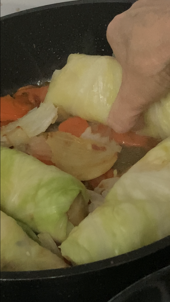 Pacing Cabbage Rolls in Pot above Vegetable Padding for vegan cabbage rolls 