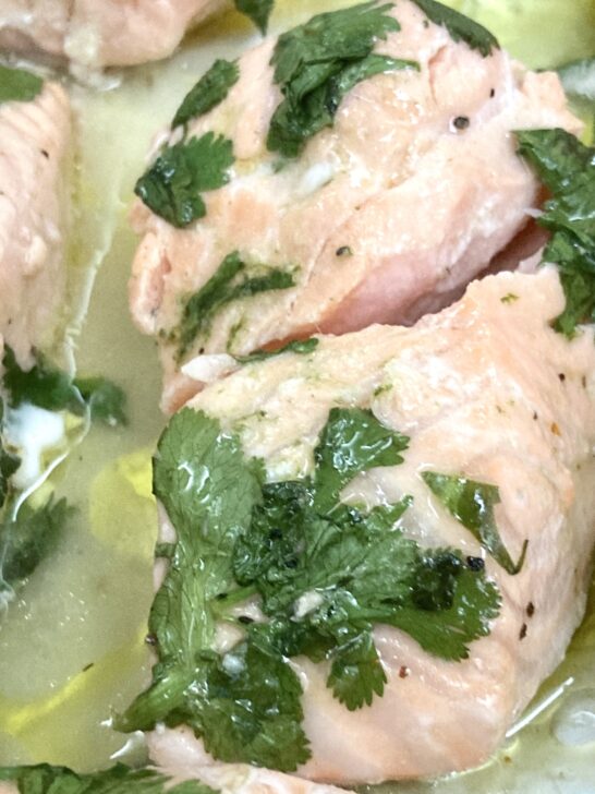 Easy Baked Salmon Recipe Appetizer in cilantro leaves in pan after baking