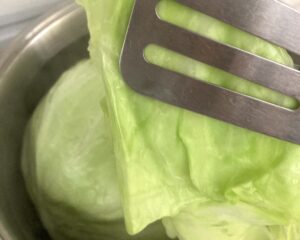 Parboiling cabbage and detaching leaves