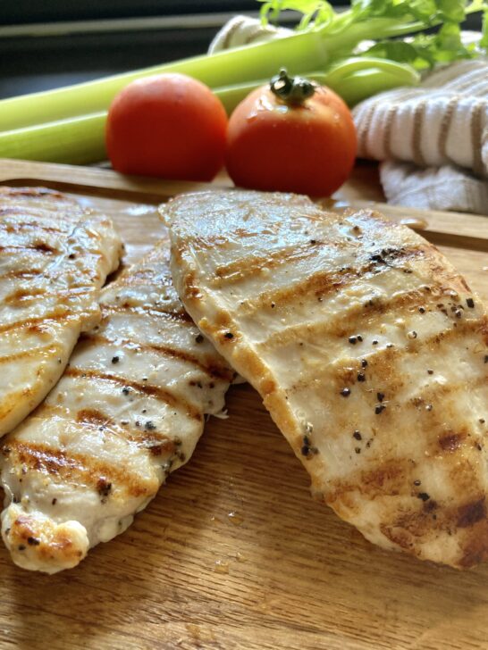 Griddled Chicken Breasts with Nigella Seeds on a cast iron, now displaying on a board
