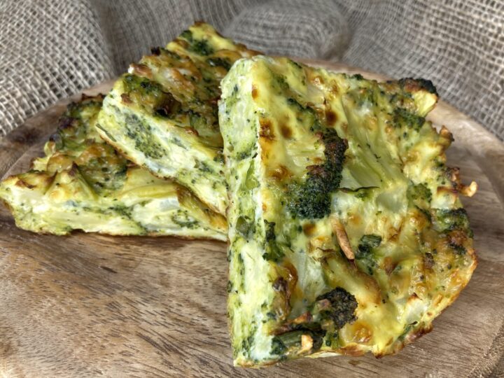 broccoli parmesan cheese casserole slices on wooden platter