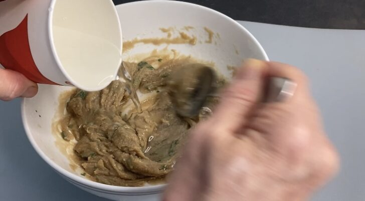 adding water to create tahini dip